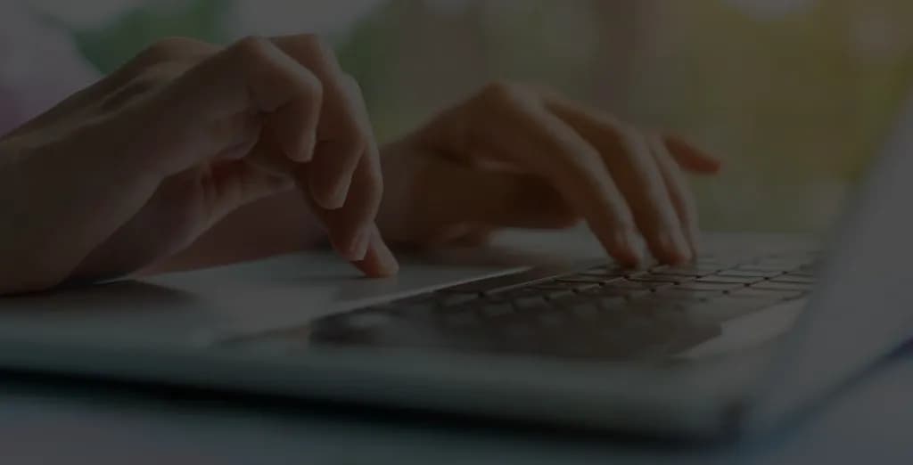 Creator typing on a laptop keyboard